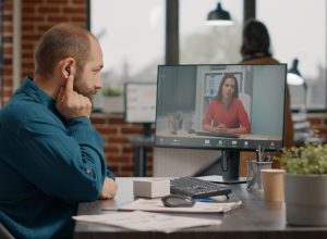 employee-talking-manager-using-video-call-earpods-computer-desk-business-man-attending-meeting-with-colleague-discuss-marketing-strategy-remote-online-video-conference (1)